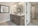 Bathroom featuring double sinks, stylish vanity, and a doorway leading to a walk-in closet at 113 O'Leary Circle, Summerville, SC 29483