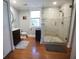 Elegant bathroom featuring a glass shower with marble tile and hardwood floors at 14 Gordon St, Charleston, SC 29403