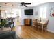 Bright and airy living space with hardwood floors, dining area, and a view into the kitchen at 14 Gordon St, Charleston, SC 29403