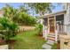 Landscaped backyard with a screened porch and lush greenery at 517 Royall Ave, Mount Pleasant, SC 29464