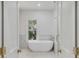 Bright bathroom with a modern freestanding tub, natural light, and stylish fixtures, creating a serene and relaxing atmosphere at 517 Royall Ave, Mount Pleasant, SC 29464