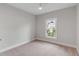 Neutral-colored bedroom featuring a ceiling fan and large window with backyard view at 517 Royall Ave, Mount Pleasant, SC 29464