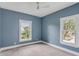 Blue bedroom with two large windows offering natural light and neighborhood views at 517 Royall Ave, Mount Pleasant, SC 29464