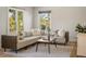 Sun-drenched living room featuring a large sectional sofa, patterned rug, and natural light, perfect for relaxation at 517 Royall Ave, Mount Pleasant, SC 29464