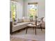 Bright and airy living room featuring a large sectional sofa, natural light, and a wood coffee table on patterned rug at 517 Royall Ave, Mount Pleasant, SC 29464