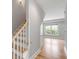 Bright staircase with hardwood steps and white railings, leading to the living area at 517 Royall Ave, Mount Pleasant, SC 29464