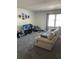 Bright living room featuring plush carpet, a comfortable sofa, and a large window offering ample natural light at 2150 Spoleto Ln # B-6, North Charleston, SC 29406