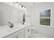 Modern bathroom with white double sink vanity, marble floor, and a large mirror at 2833 Auldreeke Rd, Johns Island, SC 29455
