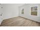 Bright bedroom featuring hardwood floors, two windows providing natural light, and neutral walls at 2833 Auldreeke Rd, Johns Island, SC 29455