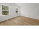 Bright bedroom featuring hardwood floors, two windows providing natural light, and neutral walls at 2833 Auldreeke Rd, Johns Island, SC 29455