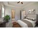 Bedroom with neutral décor, ceiling fan, and access to ensuite bath and closets at 2833 Auldreeke Rd, Johns Island, SC 29455
