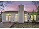 Rear view of house showcasing the deck and windows at dusk at 100 Kingsbridge Dr, Goose Creek, SC 29445