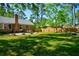 Spacious backyard with a patio, outdoor seating, a wooden fence, and mature trees at 125 Bramwell Dr, Summerville, SC 29485