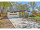 Charming single-story home with a new driveway, modern facade, lovely landscaping, and vibrant turquoise door at 32 Briarcliff Dr, Charleston, SC 29407