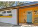 Quaint home exterior with teal front door and wood siding at 32 Briarcliff Dr, Charleston, SC 29407
