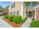 Close-up of the home's front exterior, showcasing tan siding, brick accents, and manicured shrubs at 177 Thousand Oaks Cir, Goose Creek, SC 29445