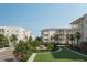 Beautiful low-rise apartment buildings featuring multi-level balconies and lush green landscaping in a serene community setting at 540 Helmsman St # 1221, Daniel Island, SC 29492