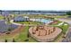 Community playground with swings, slides, and climbing structures, set against a backdrop of homes and green landscaping at 129 Grange Cir, Summerville, SC 29486