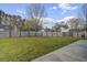 Large backyard with green grass, surrounded by a tall wooden privacy fence at 174 Education Blvd, Ladson, SC 29456