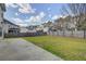 Large backyard with a privacy fence and a concrete patio area extending from the home at 174 Education Blvd, Ladson, SC 29456