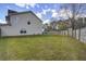 Lawn and fence view showcasing the spacious backyard, home's exterior, and greenery at 174 Education Blvd, Ladson, SC 29456