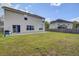 Expansive backyard view featuring a spacious lawn, patio area, and a barbecue grill at 174 Education Blvd, Ladson, SC 29456