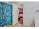 Bright bathroom featuring wood vanity, large mirror, and a shower with a decorative floral curtain at 174 Education Blvd, Ladson, SC 29456