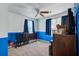 Bedroom featuring half painted walls, ceiling fan, and blue curtains at 174 Education Blvd, Ladson, SC 29456