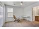 Bright bedroom with a rocking chair near the window and a connecting door to the bathroom at 174 Education Blvd, Ladson, SC 29456