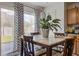 Inviting dining area with stylish curtains, a wooden table, and sliding glass doors leading to the backyard at 174 Education Blvd, Ladson, SC 29456