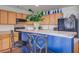 Bright kitchen with a breakfast bar, wood cabinets, sleek appliances, and overhead lighting at 174 Education Blvd, Ladson, SC 29456