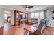 Spacious living room featuring laminate floors, ceiling fan, a large window, and access to the Primary bedroom at 174 Education Blvd, Ladson, SC 29456