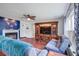 Comfortable living room offering laminate flooring, ceiling fan, decorative elements, and a cozy fireplace at 174 Education Blvd, Ladson, SC 29456