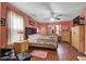 Relaxing bedroom with wood-look floors, ceiling fan, and warm lighting, creating a comfortable, personal space at 174 Education Blvd, Ladson, SC 29456