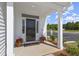 Inviting front porch with black front door,potted plants, and a welcoming mat at 472 Rowley Ln, Summerville, SC 29486