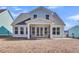 Light blue two-story home with a screened-in porch and view of the backyard at 746 Opal Wing St, Moncks Corner, SC 29461