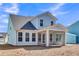 Light blue two-story home featuring an outdoor screened-in patio and a spacious backyard at 746 Opal Wing St, Moncks Corner, SC 29461
