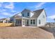 Light blue two-story home featuring an outdoor screened-in patio and a spacious backyard at 746 Opal Wing St, Moncks Corner, SC 29461