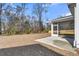 Backyard view featuring an outdoor concrete patio with a screened-in porch at 746 Opal Wing St, Moncks Corner, SC 29461