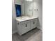 Double vanity bathroom with white cabinets and gray tile floor at 746 Opal Wing St, Moncks Corner, SC 29461