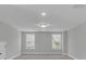 Light-filled bedroom showcasing recessed lights, carpet and two bright windows at 746 Opal Wing St, Moncks Corner, SC 29461