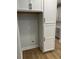 White shaker cabinets with black hardware in a kitchen pantry at 746 Opal Wing St, Moncks Corner, SC 29461