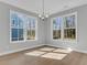 Light-filled living room featuring gorgeous floor and multiple light-filled windows at 746 Opal Wing St, Moncks Corner, SC 29461