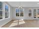 Sunlit living room featuring beautiful floors, large windows, and neutral walls at 746 Opal Wing St, Moncks Corner, SC 29461