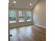 Large main bedroom with hardwood floors and multiple windows at 746 Opal Wing St, Moncks Corner, SC 29461