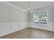 Bright dining room featuring elegant molding, a modern chandelier, and large windows with a neighborhood view at 364 Wappoo Trace Ln, Summerville, SC 29486
