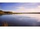 Image showcasing a serene lake view reflecting the blue sky and surrounding greenery at 369 Wappoo Trace Ln, Summerville, SC 29486