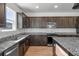 Modern kitchen with dark wood cabinets and granite countertops at 109 Darby Meadow Ln, Ridgeville, SC 29472