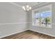 Dining room with wood floors, neutral walls, chair rail and a modern chandelier fixture at 176 Cantona Dr, Summerville, SC 29483
