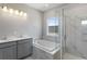 This spacious bathroom boasts a dual sink vanity, tub, and glass-enclosed shower at 341 Trailmore Ln, Summerville, SC 29486